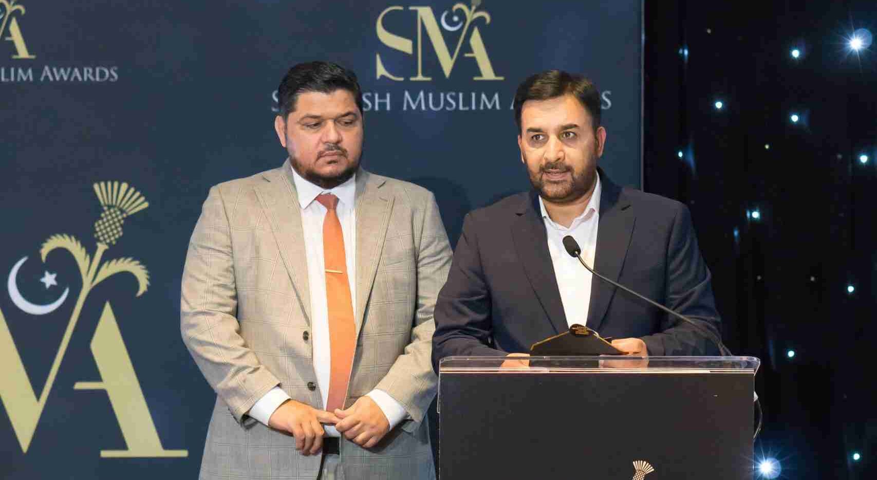 Aghosh UK Executive Director Abid Hussain speaking at the podium at the Scottish Muslim Awards 2026
