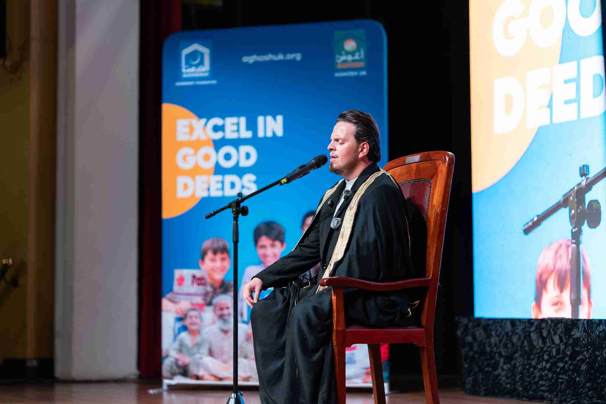 Nasheed artist Egzon Ibrahimi performing a seated recitation during the Nasheed Nights Tour: Echoes of Kindness